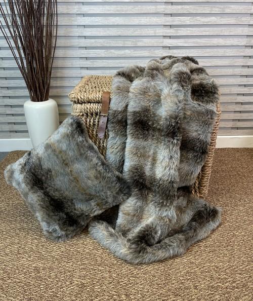 Grey and brown striped fur throw and fur cushion