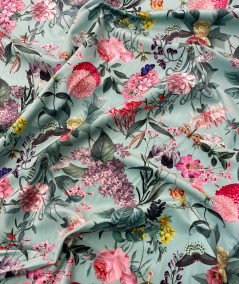 Printed velvet fabric in aqua with a pink floral design