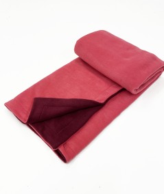 Reversible pink and maroon fleece blanket