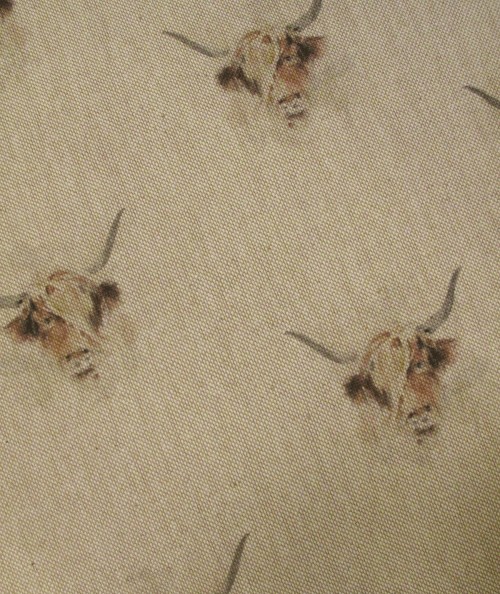 Close up image of the cow print seat pad fabric